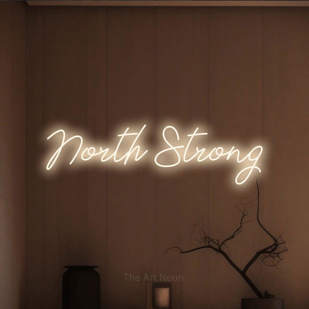 Enseigne néon à DEL à lumière blanche chaude, de style manuscrit, affichant « North Strong » sur un mur brun chaleureux