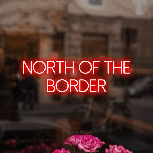 Enseigne néon à DEL à lumière rouge, affichant « North of the Border » dans un intérieur de café légèrement flou