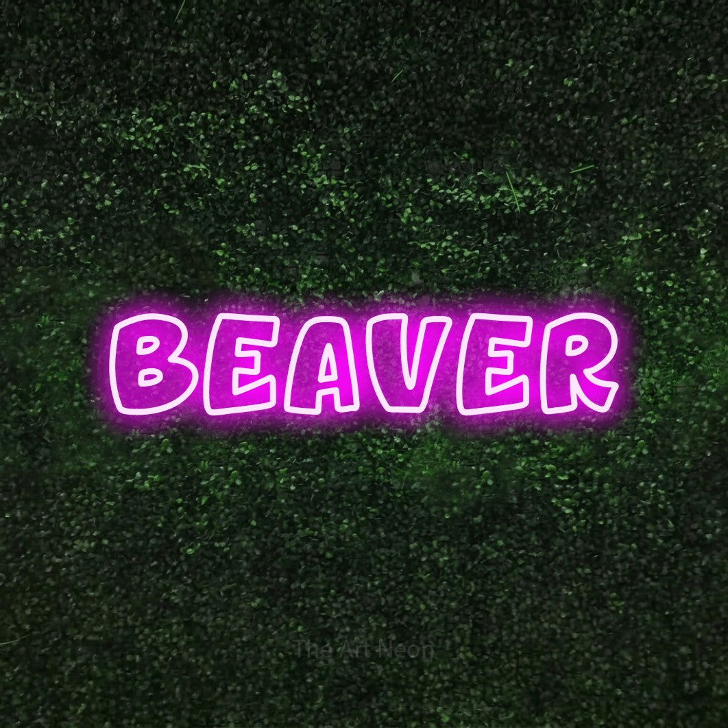 Pink outline-style LED neon sign reading "Beaver" against a textured green moss wall