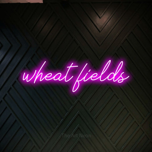 Pink script-style LED neon sign reading "Wheat Fields" against a dark geometric wood wall