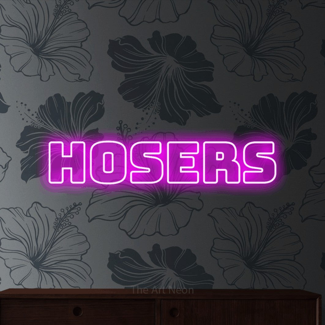 Pink outline-style LED neon sign reading "Hosers" against grey floral wallpaper