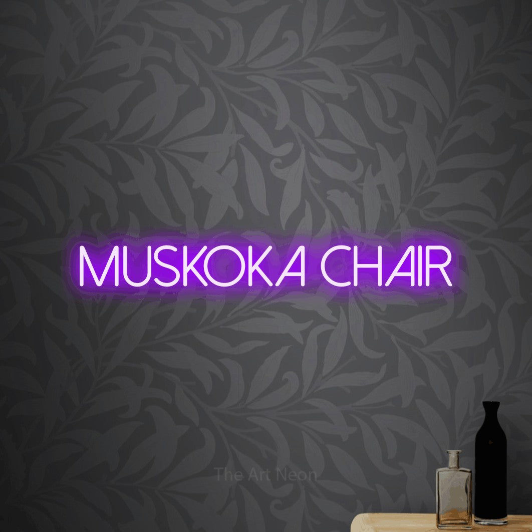 Purple LED neon sign reading "Muskoka Chair" against light grey floral wallpaper