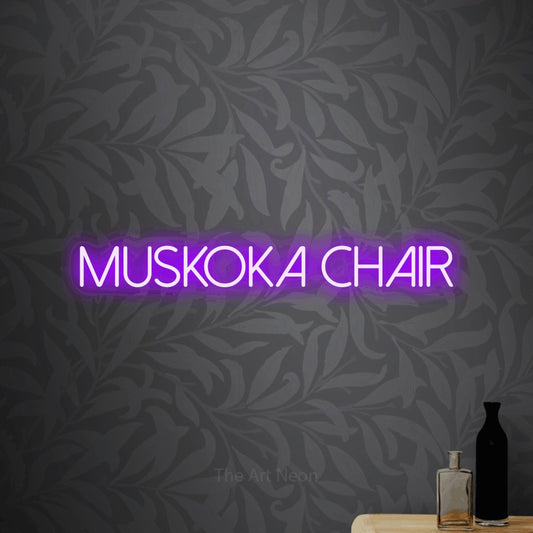 Purple LED neon sign reading "Muskoka Chair" against light grey floral wallpaper