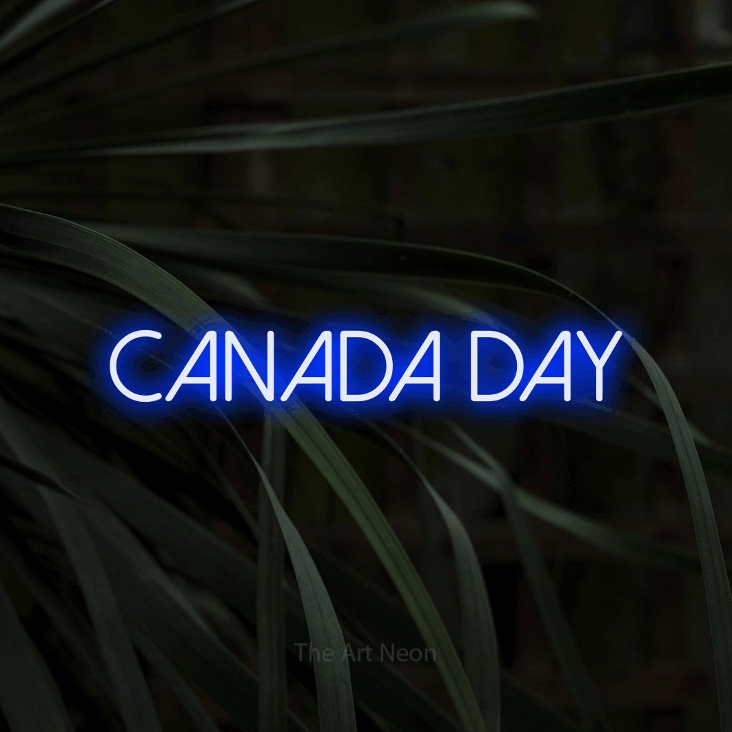 Enseigne néon à DEL à lumière bleue, affichant « Canada Day » sur des feuilles tropicales foncées