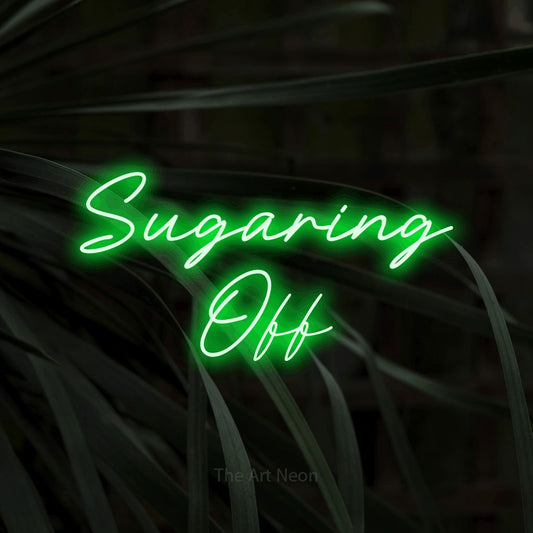 Green LED neon sign reading "Sugaring Off" against dark tropical leaves