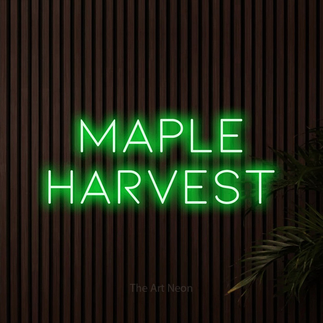Enseigne néon à DEL à lumière verte, affichant « Maple Harvest » sur des lattes de bois foncé