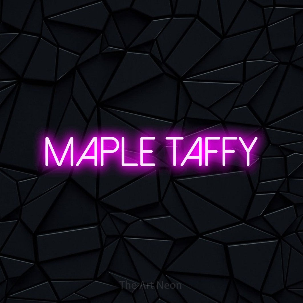 Pink LED neon sign reading "Maple Taffy" against a black faceted wall