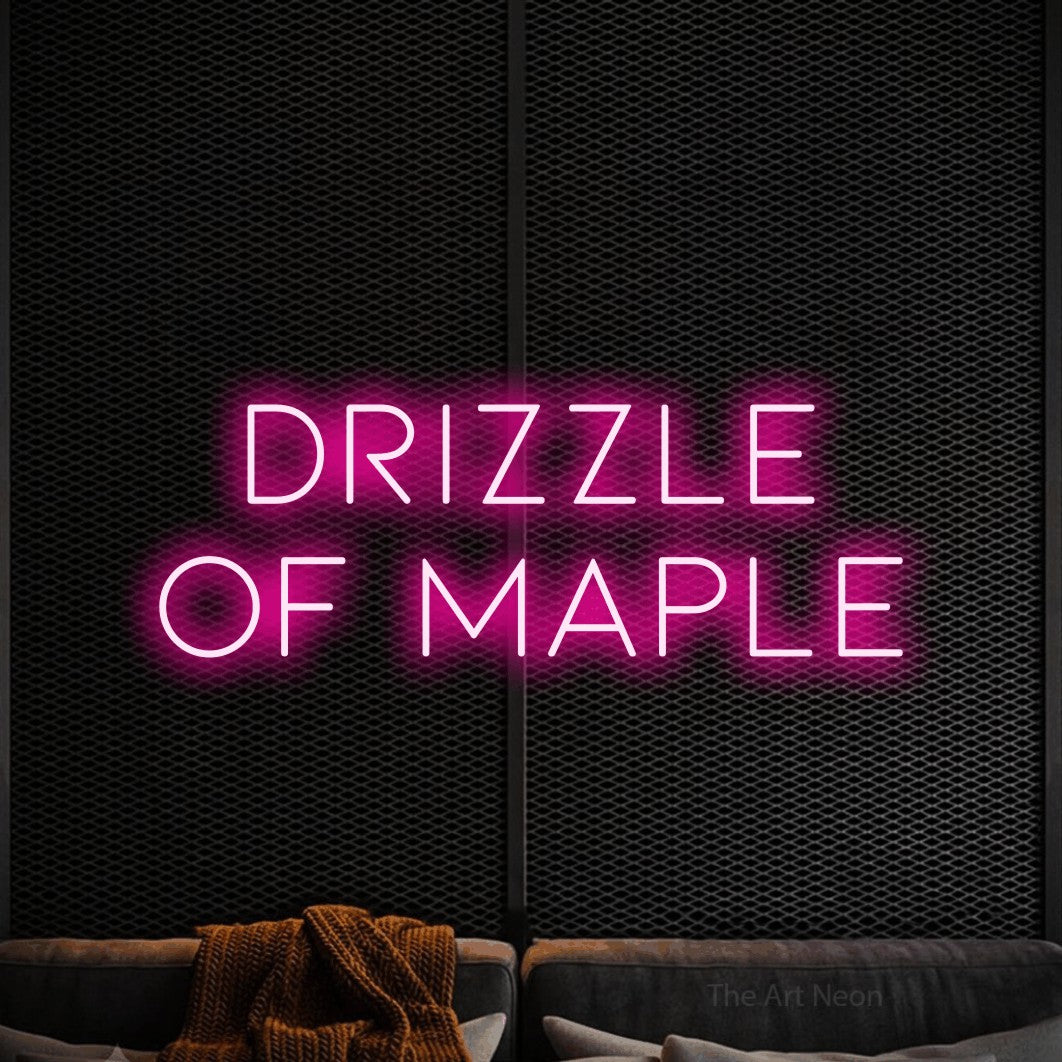 Hot pink LED neon sign reading "Drizzle of Maple" against a black textured wall