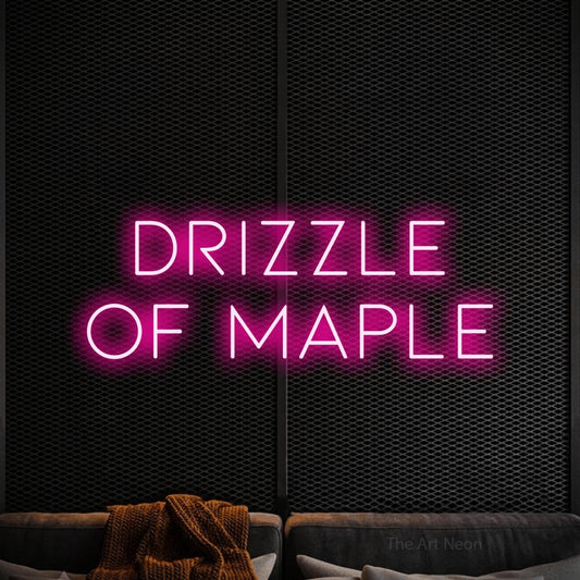 Hot pink LED neon sign reading "Drizzle of Maple" against a black textured wall