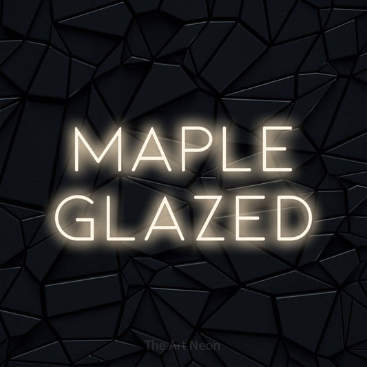 Warm white LED neon sign reading "Maple Glazed" against a black faceted wall