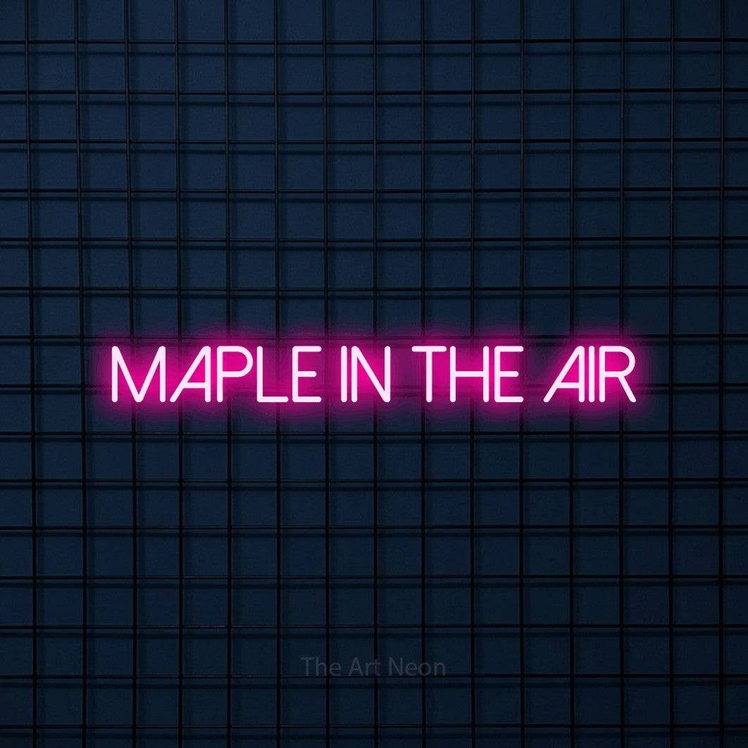 Hot pink LED neon sign reading "Maple in the Air" against a dark blue tiled wall