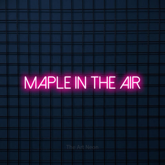 Hot pink LED neon sign reading "Maple in the Air" against a dark blue tiled wall
