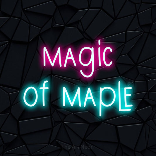Ice blue and hot pink LED neon sign reading "Magic of Maple" against a black faceted wall