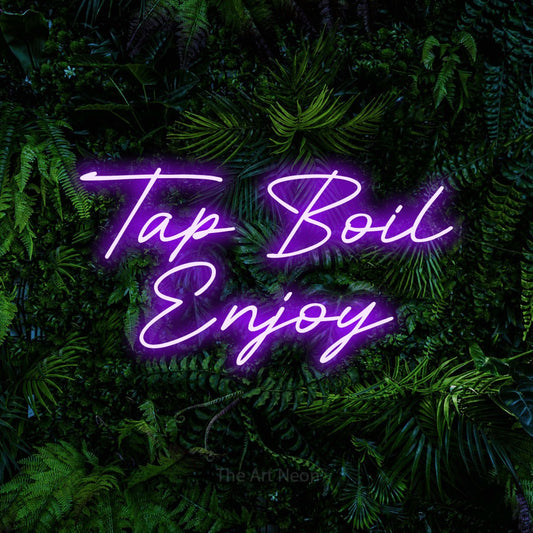 Purple LED neon sign reading "Tap Boil Enjoy" against a dense tropical foliage wall