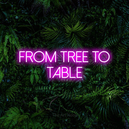 Pink LED neon sign reading "From Tree to Table" against a dense tropical foliage wall