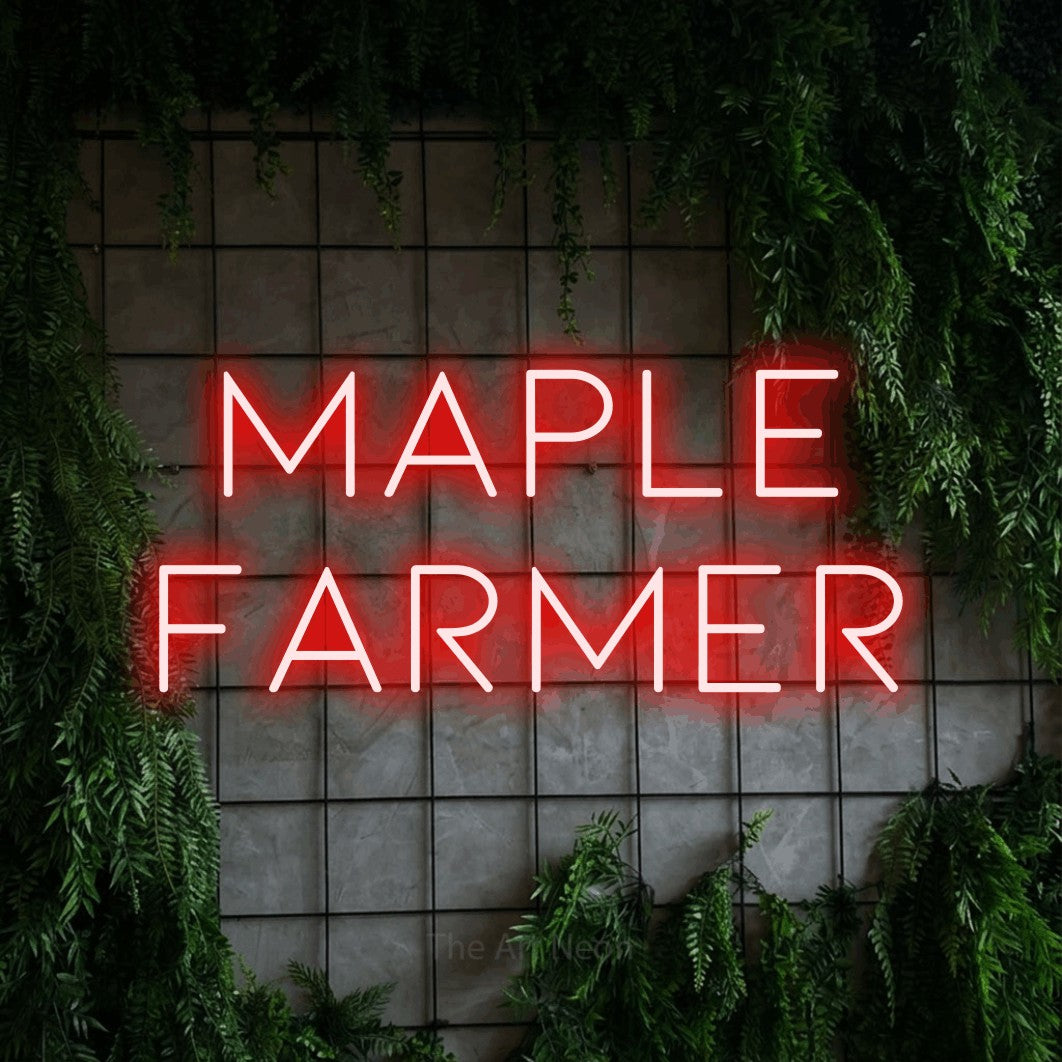 Enseigne néon à DEL à lumière rouge, affichant « Maple Farmer » sur un mur quadrillé vert avec du feuillage
