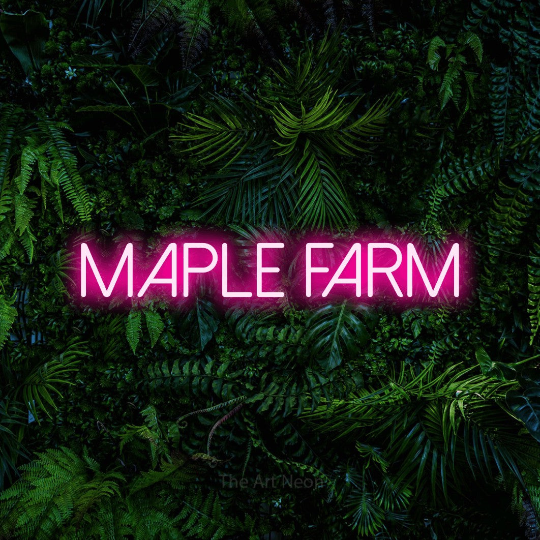 Hot pink LED neon sign reading "Maple Farm" against a dense tropical foliage wall