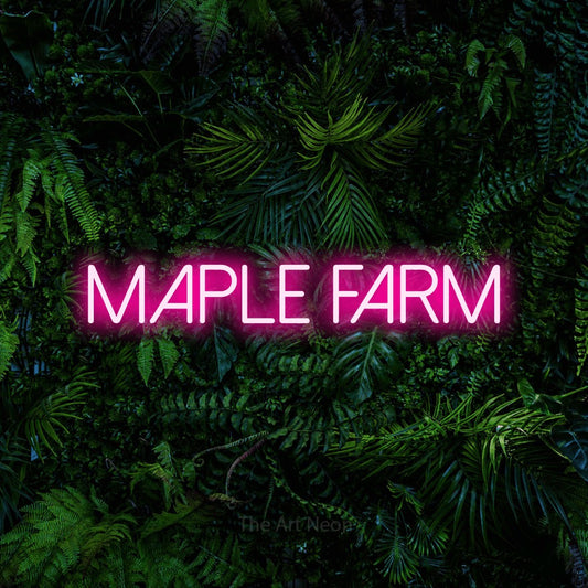 Hot pink LED neon sign reading "Maple Farm" against a dense tropical foliage wall