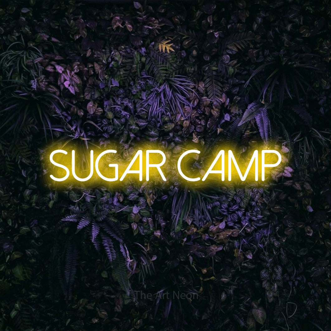 Yellow LED neon sign reading "Sugar Camp" against a purple floral wall