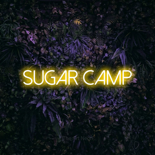 Yellow LED neon sign reading "Sugar Camp" against a purple floral wall