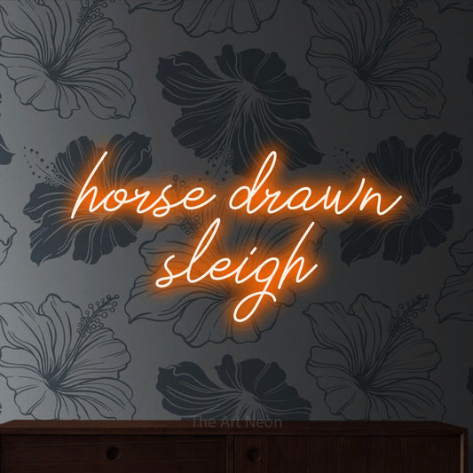 Orange script-style LED neon sign reading "Horse Drawn Sleigh" against grey floral wallpaper