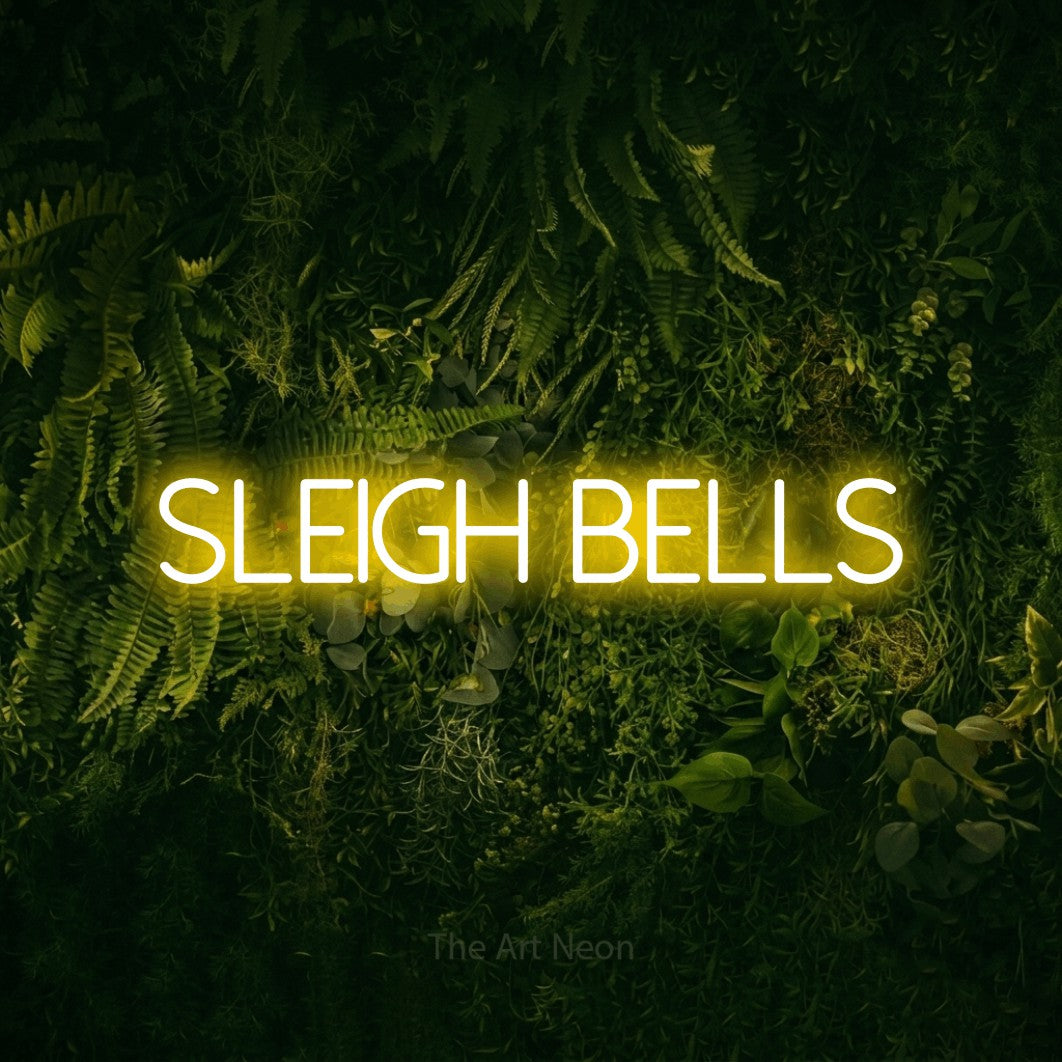 Yellow LED neon sign reading "Sleigh Bells" against a moss-covered green wall