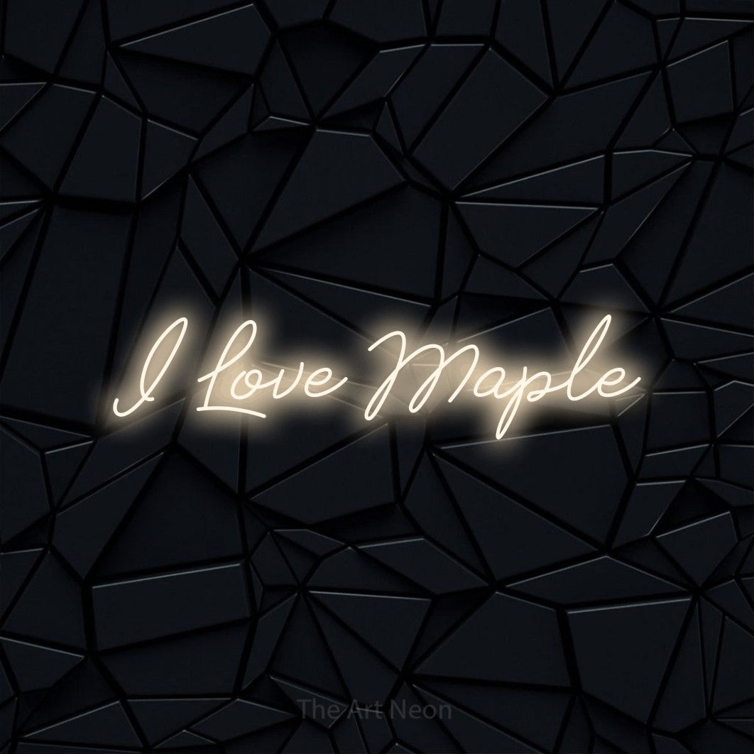 Warm white script-style LED neon sign reading "I Love Maple" against a black faceted wall