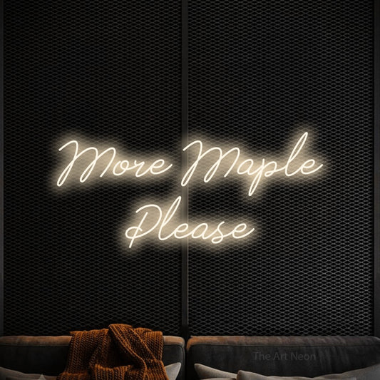Warm white script-style LED neon sign reading "More Maple Please" against a black textured wall