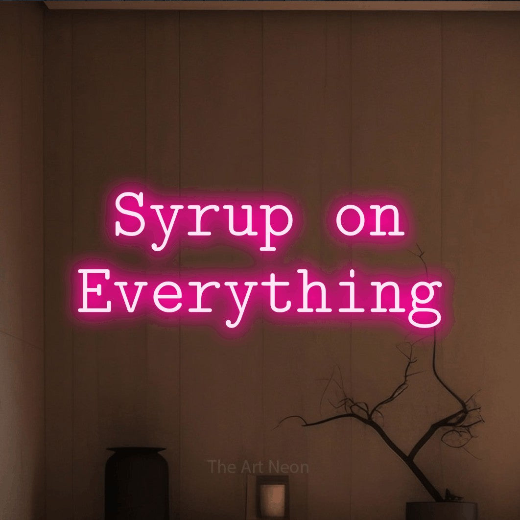 Hot pink LED neon sign reading "Syrup on Everything" against a warm brown wall