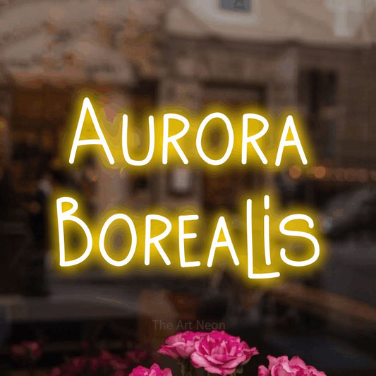 Yellow LED neon sign reading "Aurora Borealis" in a softly blurred café interior