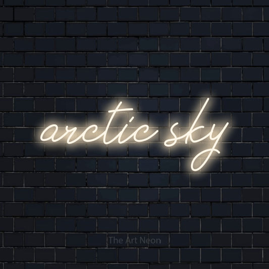 Warm white script-style LED neon sign reading "Arctic Sky" against a dark navy brick wall