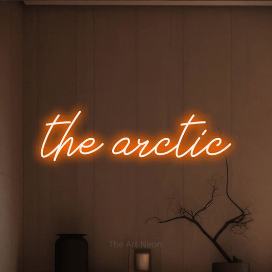 Orange script-style LED neon sign reading "The Arctic" against a warm brown wall