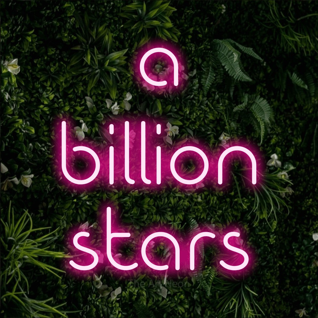 Hot pink LED neon sign reading "A Billion Stars" against a leafy green wall