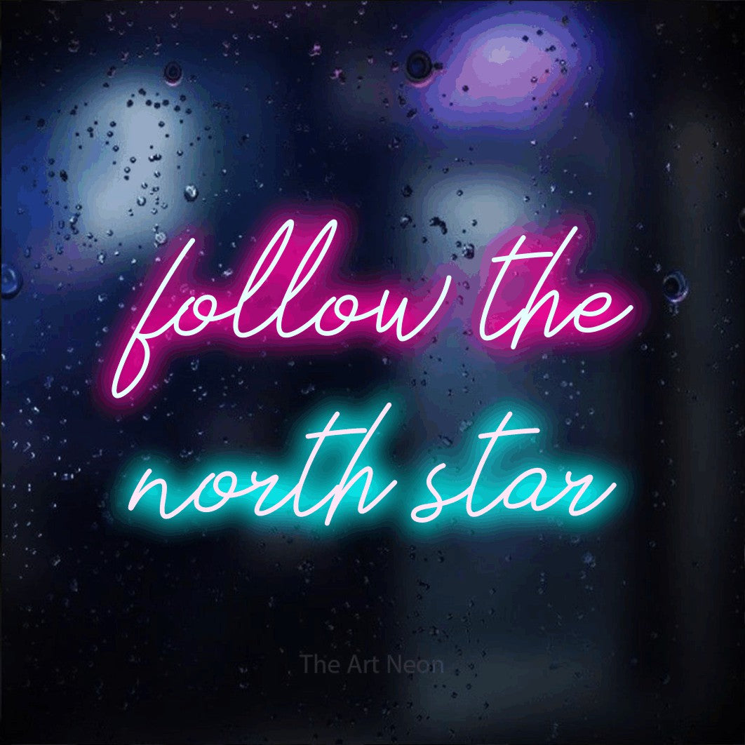 Ice blue and hot pink script-style LED neon sign reading "Follow the North Star" against a dark blue bokeh background