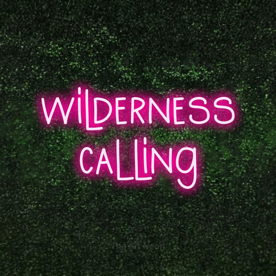 Hot pink LED neon sign reading "Wilderness Calling" against a textured green moss wall