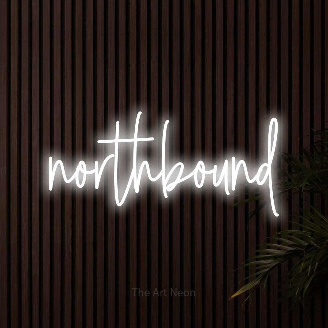 Cool white script-style LED neon sign reading "Northbound" against dark wooden slats