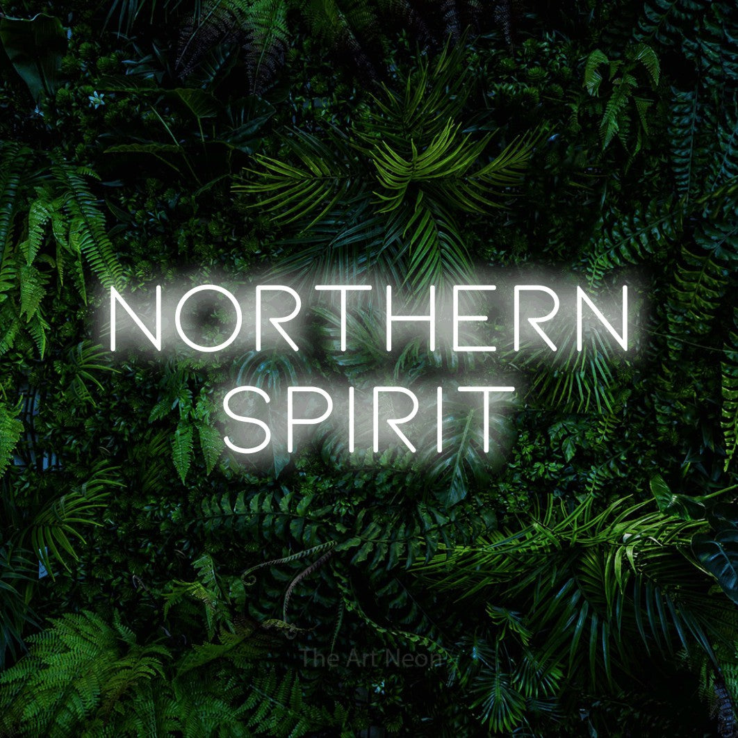 Cool white LED neon sign reading "Northern Spirit" against a dense tropical foliage wall