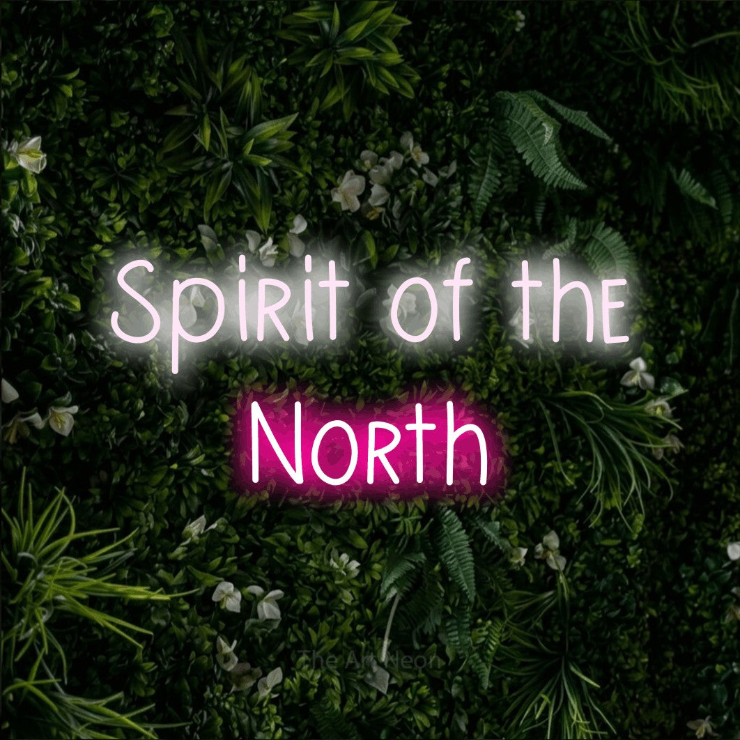 Hot pink and cool white LED neon sign reading "Spirit of the North" against a leafy green wall