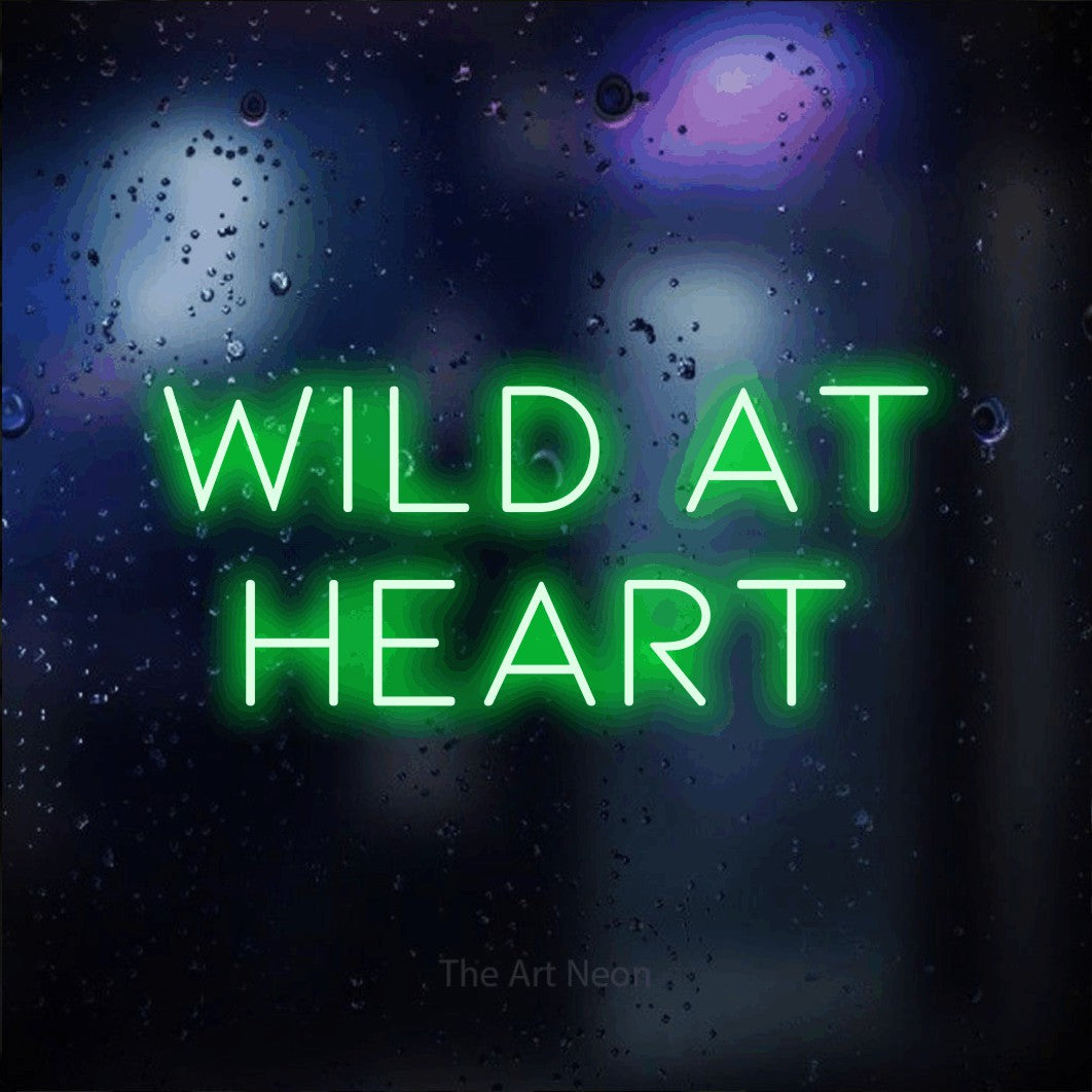 Green LED neon sign reading "Wild at Heart" against a dark blue bokeh background