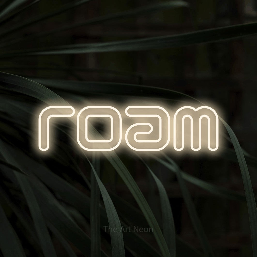 Warm white outline-style LED neon sign reading "Roam" against dark tropical leaves