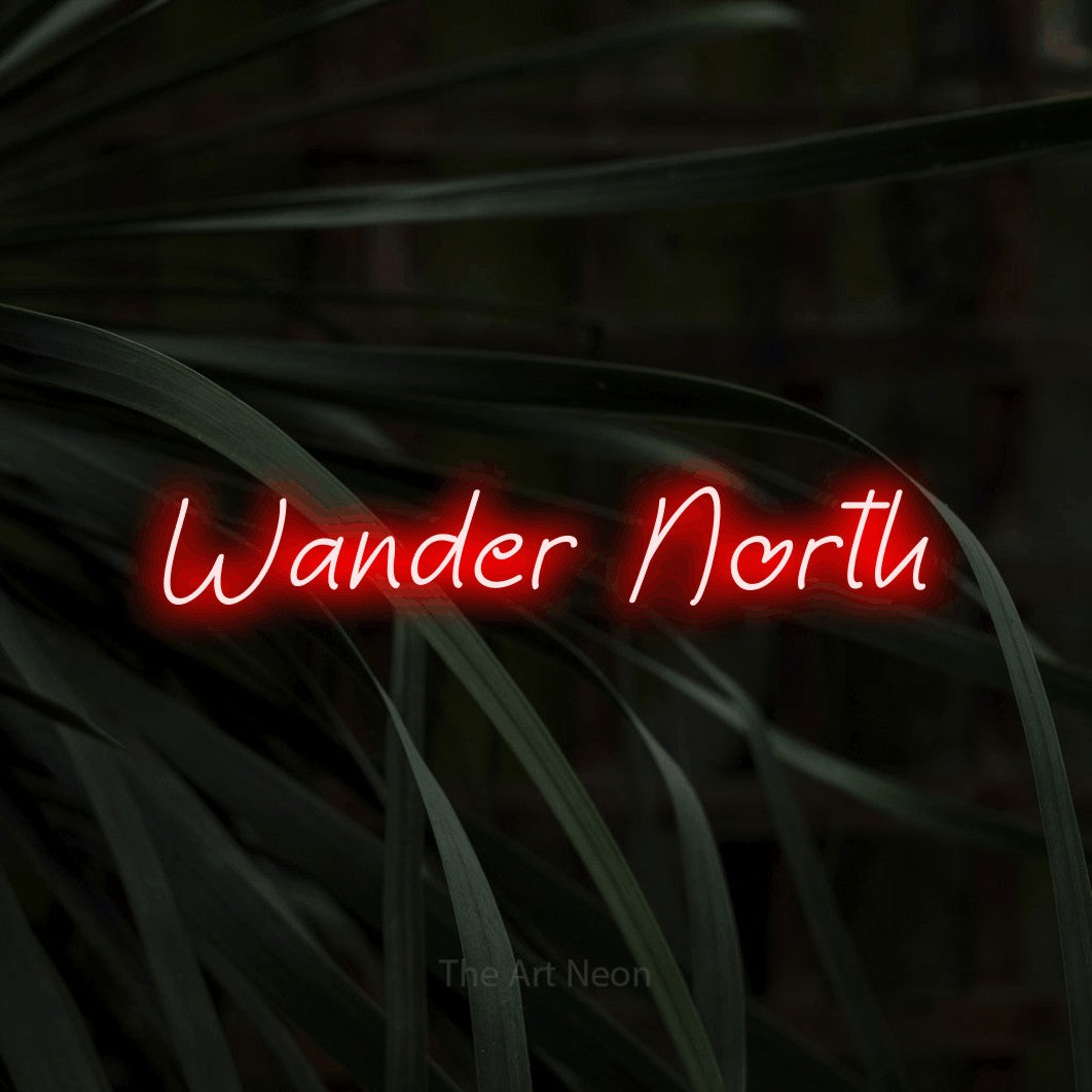 Red LED neon sign reading "Wander North" against dark tropical leaves
