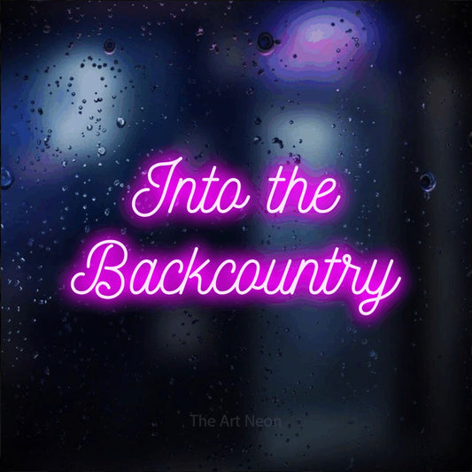 Pink script-style LED neon sign reading "Into the Backcountry" against a dark blue bokeh background
