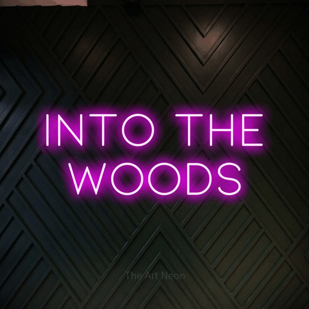 Pink LED neon sign reading "Into the Woods" against a dark geometric wood wall