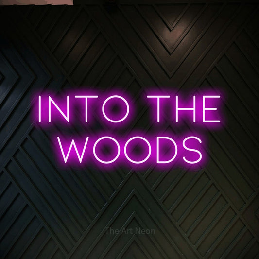 Pink LED neon sign reading "Into the Woods" against a dark geometric wood wall