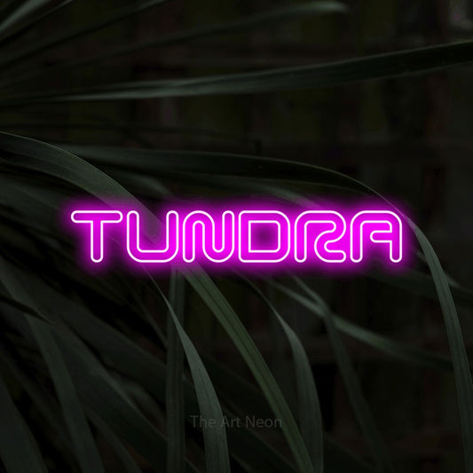 Pink outline-style LED neon sign reading "Tundra" against dark tropical leaves
