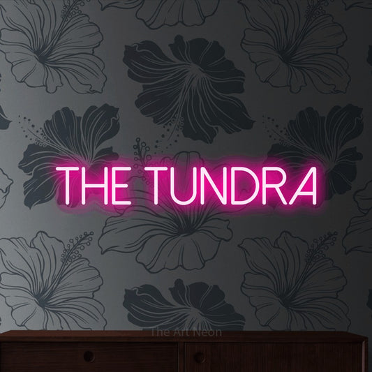 Hot pink LED neon sign reading "The Tundra" against grey floral wallpaper