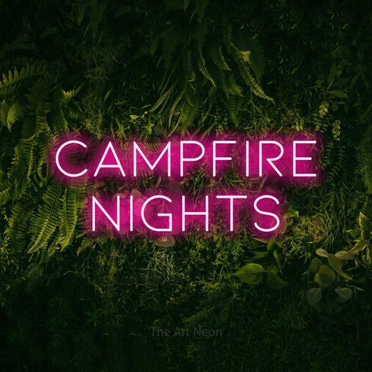 Hot pink LED neon sign reading "Campfire Nights" against a moss-covered green wall