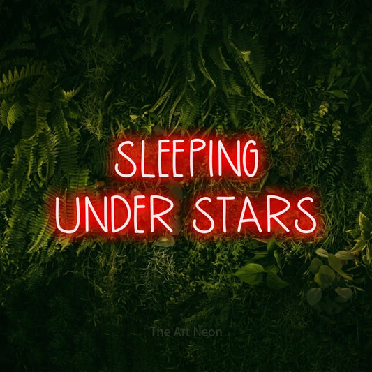 Red LED neon sign reading "Sleeping Under Stars" against a moss-covered green wall