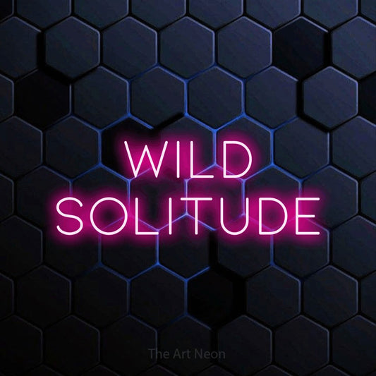 Hot pink LED neon sign reading "Wild Solitude" against a blue hexagonal wall