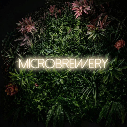 Warm white LED neon sign reading "Microbrewery" against a flowering garden wall
